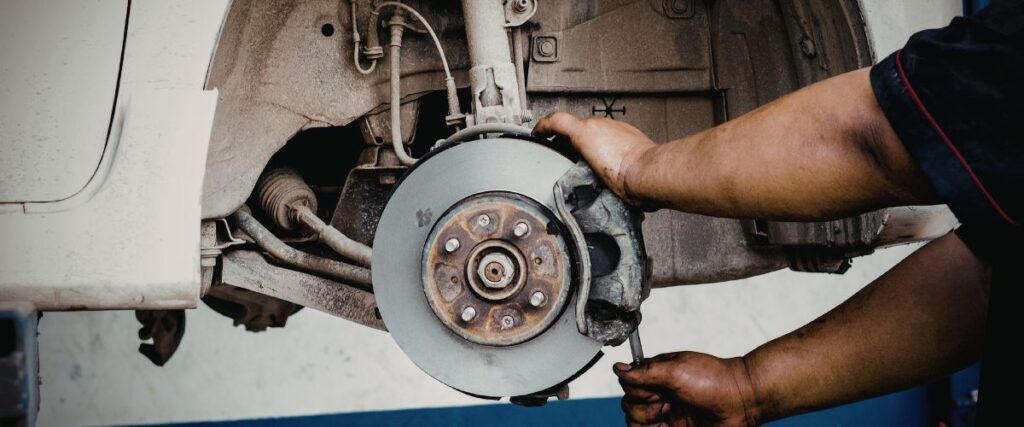 mechanic repairing brake system components