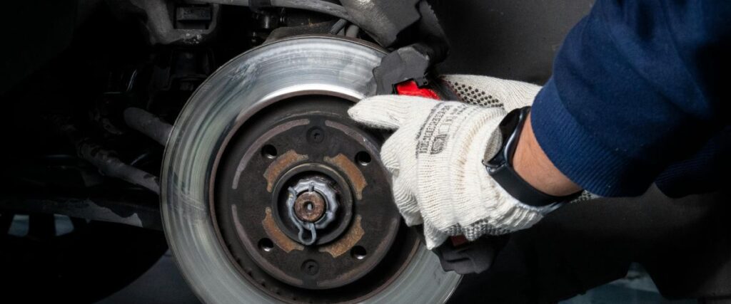 mechanic replacing brake pads and rotors