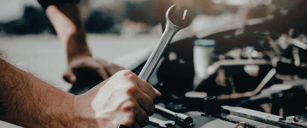 mechanic inspecting engine for vibration issue
