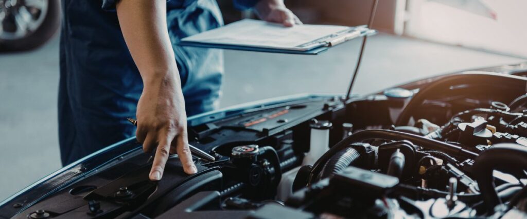 mechanic inspecting engine mounts for vibration